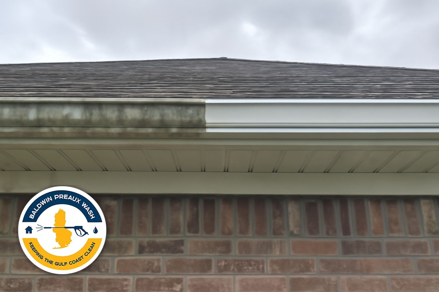 Gutter packed with pine straw and oak debris on a Spanish Fort home before cleaning