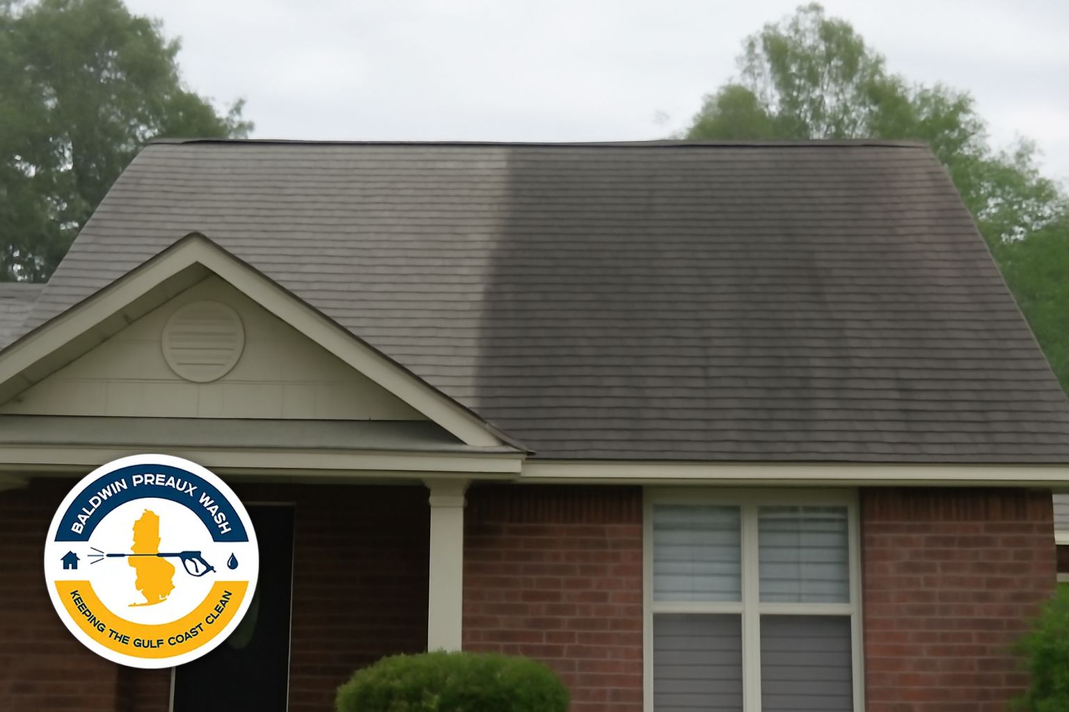 Baldwin Preaux Wash technician rinsing a soft-washed shingle roof on a Daphne residential home after algae treatment